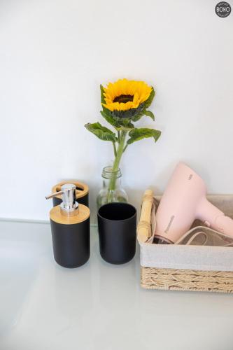 a vase with a yellow flower in a vase at BOHO Boutique Bungalows in Baan Tai