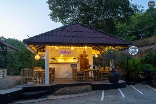a restaurant with a table and chairs and lights at BOHO Boutique Bungalows in Baan Tai