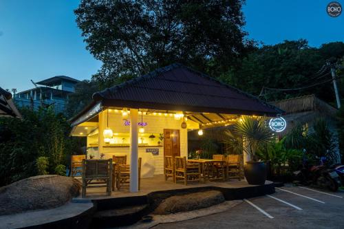 a restaurant with tables and chairs and lights at BOHO Boutique Bungalows in Baan Tai
