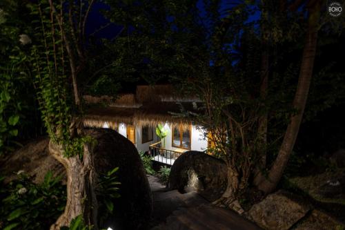 a house in the woods at night at BOHO Boutique Bungalows in Baan Tai
