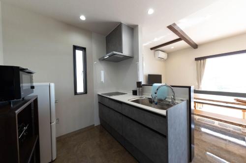 a kitchen with a sink and a counter top at Kanasha Building A - Vacation STAY 49732v in Ōkachi