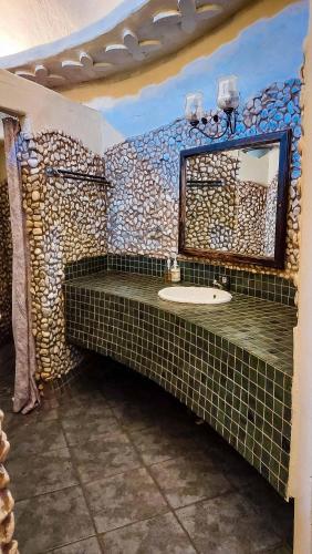 a bathroom with a sink and a mirror at Kianga Lodge & Venue in Centurion