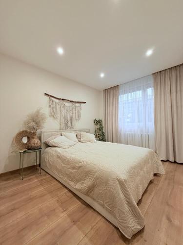 a bedroom with a large bed and a window at Apartament w sercu Żor in Żory