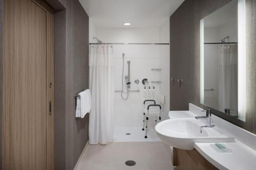 a bathroom with two sinks and a shower and a sink at SpringHill Suites by Marriott Bowling Green in Bowling Green