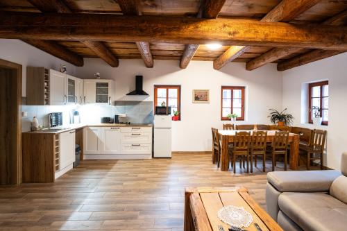 a kitchen and a living room with a table at Ubytování Pod Mostem in Broumov