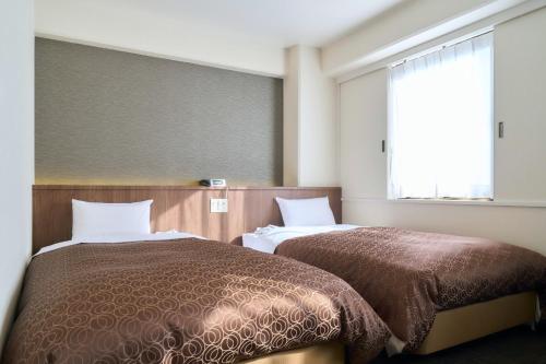 a hotel room with two beds and a window at Minakuchi Century Hotel - Vacation STAY 35331v in Koka