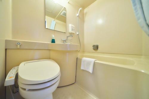a bathroom with a toilet and a sink and a tub at Minakuchi Century Hotel - Vacation STAY 35285v in Koka