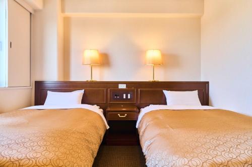 two beds in a hotel room with two lamps at Minakuchi Century Hotel - Vacation STAY 35361v in Koka