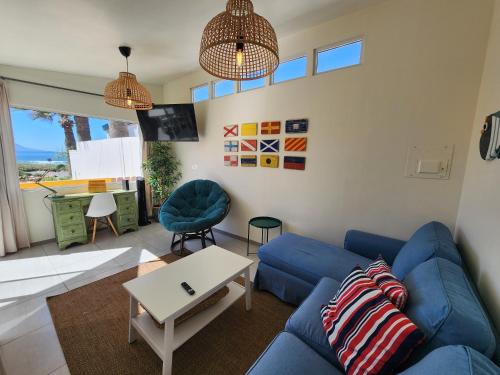 a living room with a blue couch and a table at CASA LUCIA - BEACHFRONT HOUSE in Ensenada