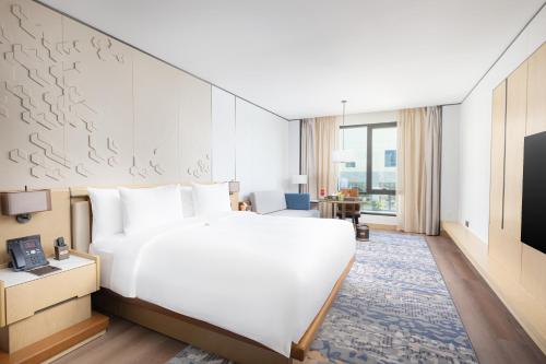a hotel room with a large bed and a tv at Braira Al Rass بريرا الرس in Al Rass