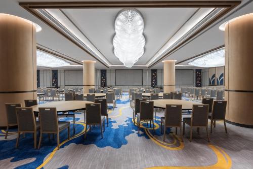 a large room with tables and chairs and a chandelier at Braira Al Rass بريرا الرس in Al Rass