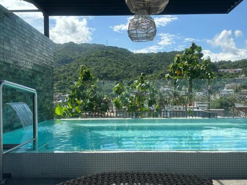 a swimming pool with a view of a mountain at Mako 54 in Puerto Vallarta