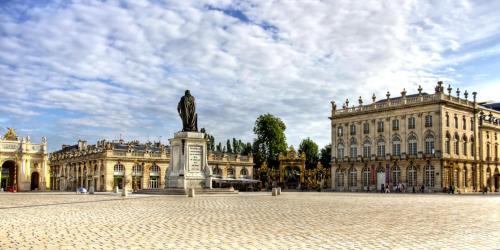 a statue in a courtyard in front of a building at Nancy Bricks Stan in Nancy