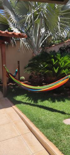 a hammock sitting on the grass in a yard at Casa temporada AURORA in São João Batista do Glória