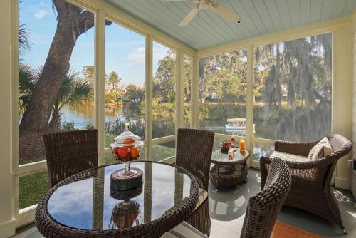 a screened in porch with a table and chairs at Montage Palmetto Bluff in Bluffton