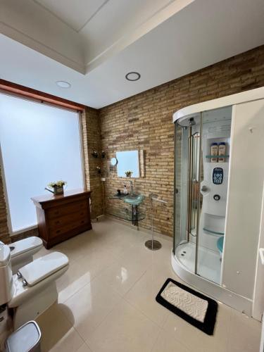 a bathroom with a shower and a toilet and a sink at IY Loft 5 - Spacious Loft in the Old Town in Valencia
