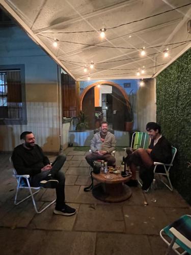 a group of men sitting in chairs around a table at Reserva 69 Hostel in Sao Paulo