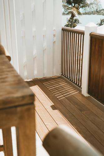 a porch with a wooden deck with a fence at La Villa Hibiscus, Saint Martin in Cul de Sac
