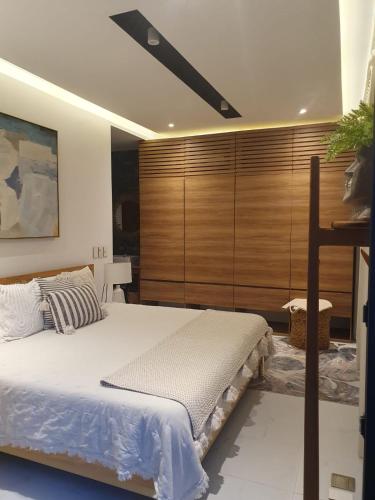 a bedroom with a bed and a wooden wall at Mako 54 in Puerto Vallarta