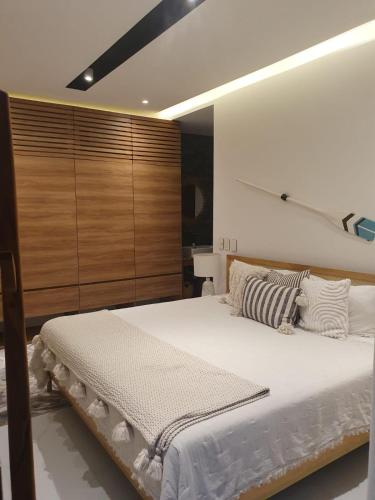 a bedroom with a large white bed in a room at Mako 54 in Puerto Vallarta