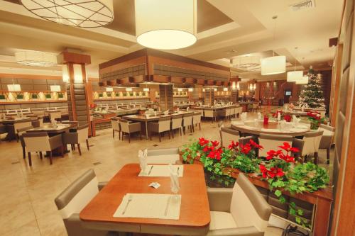 a dining room with tables and chairs and a restaurant at Ramada by Wyndham Princess Georgetown in Georgetown