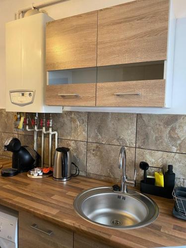 a kitchen counter with a sink in a kitchen at Complex Casa Buna Vestire in Ploieşti
