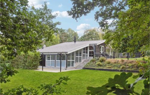 an exterior view of a house with a garden at Awesome Home In Glesborg With Sauna in Fjellerup Strand