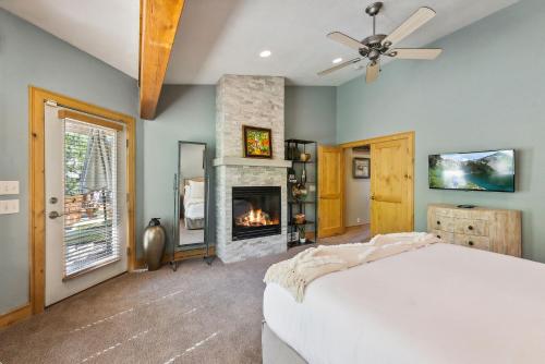 a bedroom with a bed and a fireplace at Mountain Luxury, Sleeps 10, Private Hot Tub, 15 Min to Canyons, Ideal for Family Getaways! in Park City