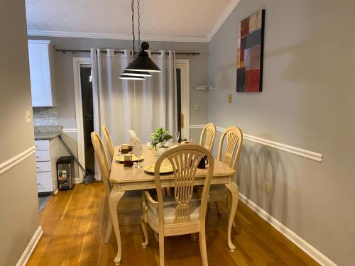 a dining room with a wooden table and chairs at Charming Family Luxury Home in Winchester