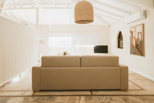 a living room with a couch in the middle at La Villa Hibiscus, Saint Martin in Cul de Sac