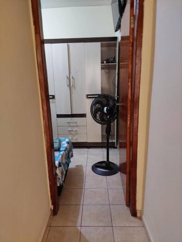 a hallway with a floor fan in a room at Kitnet bem localizada in Corumbá