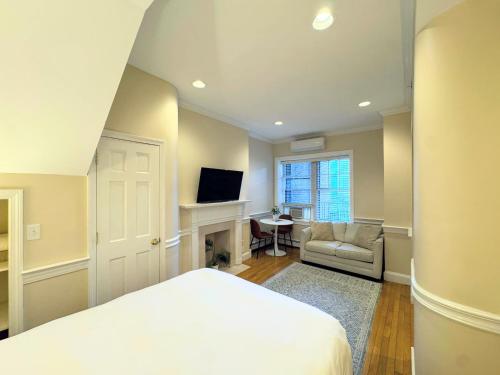 a bedroom with a bed and a living room at Copley House in Boston