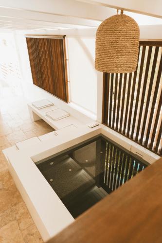 a room with a pool in the middle of a table at La Villa Hibiscus, Saint Martin in Cul de Sac