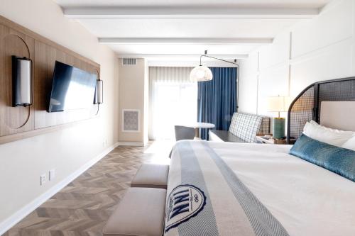 a hotel room with a bed and a couch at The Inn at Harbor Shores in Saint Joseph