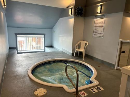 eine Whirlpool-Badewanne in der Mitte eines Zimmers in der Unterkunft Cornerstone Lodge by StayIn in Fernie
