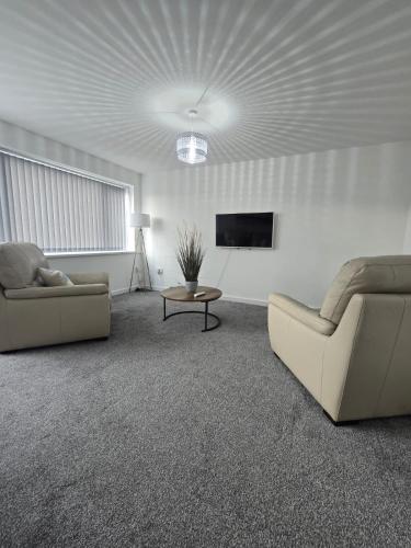a living room with two couches and a tv at New 4bedroom house near Manchester Airport in Handforth