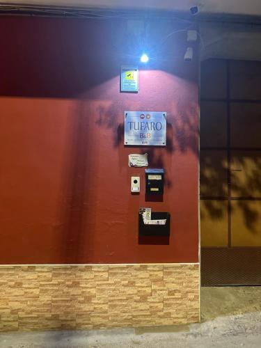 a wall with a sign that reads tulum at Tufaro B&B Private Room in Macerata Campania