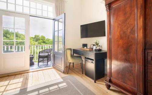 a home office with a desk and a balcony at One Kensington Boutique Hotel in Cape Town