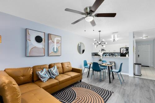 a living room with a couch and a dining room at Oasis 201 - Dune Dream in Titusville
