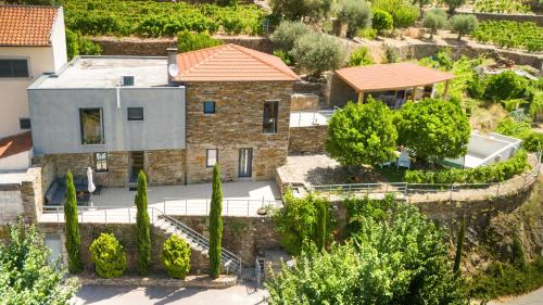 an aerial view of a house with a garden at Soalheira Douro House in Vale de Mendiz