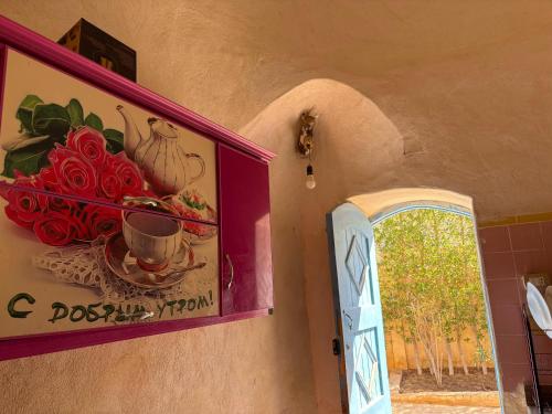 a painting on the side of a wall next to a door at Khan tunis villa in Tunis