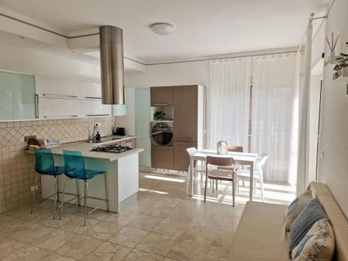 a kitchen with a counter and a table with chairs at Casa Atena in Sperlonga