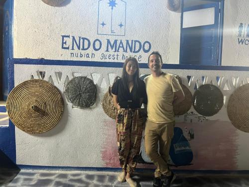 a man and a woman standing in front of a boat at Endo Mando in Shellal