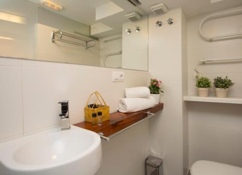a bathroom with a sink and a mirror at SingularStays Botanico 29 Rooms in Valencia