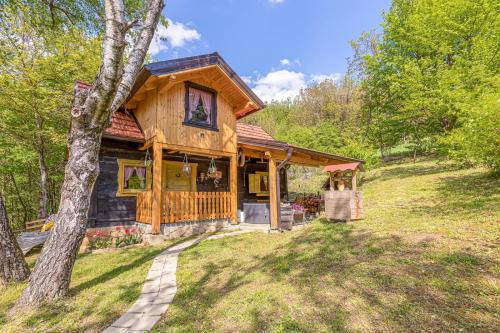 a log cabin in the woods with a tree at Chalet Birchwood With Whirlpool and Sauna - Happy Rentals in Hum Breznički