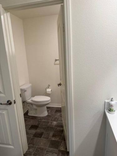 a bathroom with a white toilet in a room at A Tranquil Haven with Elegance in Menifee