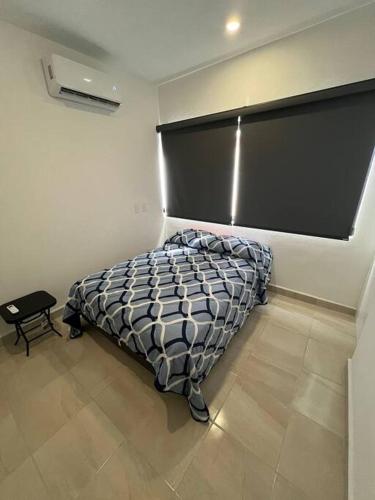 a bedroom with a bed with a black headboard at Casa Nueva con Alberca Puerto Vallarta in Puerto Vallarta