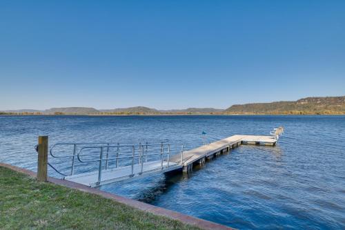 a dock in the middle of a large body of water at Dock and Views Waterfront Home in Wabasha! in Wabasha