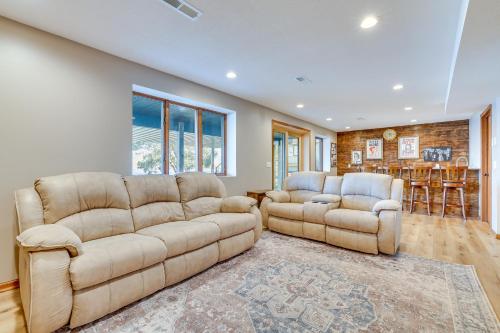 a living room with a couch and two chairs at Dock and Views Waterfront Home in Wabasha! in Wabasha