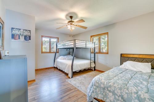 a bedroom with a bed and a ceiling fan at Dock and Views Waterfront Home in Wabasha! in Wabasha